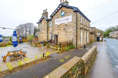 a building with a sign on the front of it at Slyne Lodge in Hest Bank
