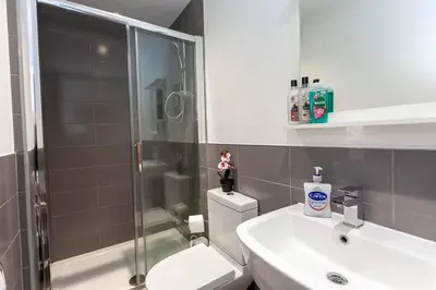 a bathroom with a shower and a toilet and a sink at Spacious 2BR -Liverpool Central - Walk to Royal Dock, Nightlife Train Station in Liverpool