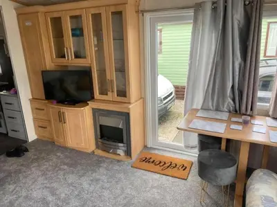 a living room with a tv and a fireplace at Spacious Caravan Morecambe Parkdean caravan Park in Morecambe