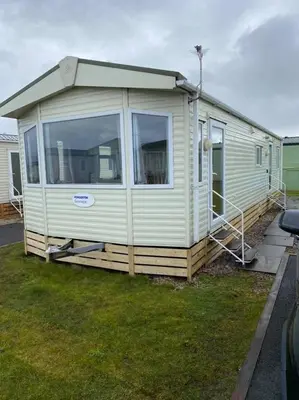 a mobile home is parked in a yard at Spacious Caravan Morecambe Parkdean caravan Park in Morecambe