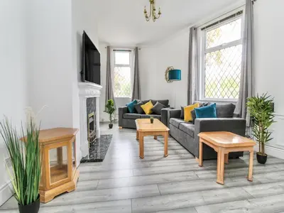 a living room with a couch and a fireplace at 2 Bed House, Sleeps 5, Ideal for Contractors, St Helens, Long Term Stays Weekly & Monthly Offers in Saint Helens