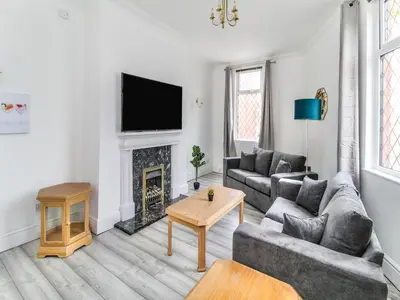 a living room with a couch and a fireplace at 2 Bed House, Sleeps 5, Ideal for Contractors, St Helens, Long Term Stays Weekly & Monthly Offers in Saint Helens