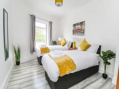 a bedroom with two beds and a window at 2 Bed House, Sleeps 5, Ideal for Contractors, St Helens, Long Term Stays Weekly & Monthly Offers in Saint Helens