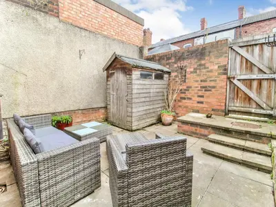 a patio with two wicker chairs and a building at 2 Bed House, Sleeps 5, Ideal for Contractors, St Helens, Long Term Stays Weekly & Monthly Offers in Saint Helens