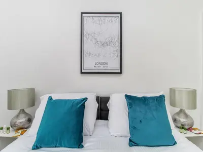 a bedroom with a white bed with blue pillows at 2 Bed House, Sleeps 5, Ideal for Contractors, St Helens, Long Term Stays Weekly & Monthly Offers in Saint Helens