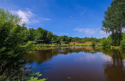 a view of a lake with houses in the background at Bowland Lakes Leisure Village in Forton