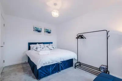 a bedroom with a bed and a mirror in it at Modern Central Preston Apt King Bed & Smart TV in Preston