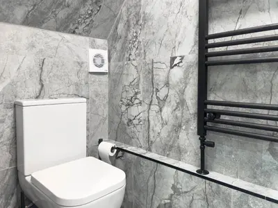 a bathroom with a toilet and a marble wall at Luxury Preston Home 3 Beds Sleeps 6 in Preston
