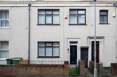 a white brick house with a black door at Luxury Preston Home 3 Beds Sleeps 6 in Preston