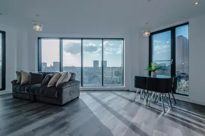 a living room with a couch and a table at Luxurious 2Bed Apartment, Sleeps 6, 3 beds in Preston