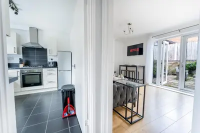 a kitchen with white appliances and a counter at Merseyside cosy 2 bed townhouse sleeps 5 in Liverpool