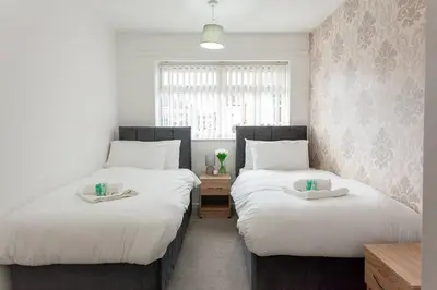 two beds sitting next to each other in a room at Close to City Centre - Mins Away from Anfield Stadium - Free Street Parking in Liverpool