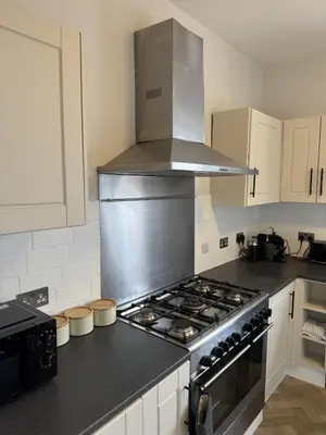 a kitchen with a stove top oven in a kitchen at Month Stays Central 3 bed Three Bedroom House by Brookland Stays Serviced Accommodation & Short Lets in Preston with Free WiFi in Farington
