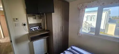 a small room with a window and a heater at BILOT Caravan in Heysham