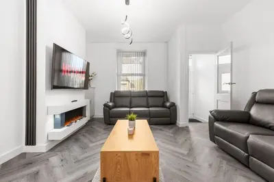 a living room with a couch and a coffee table at Modern & Stylish Stay in the Heart of St Hubert in Great Harwood