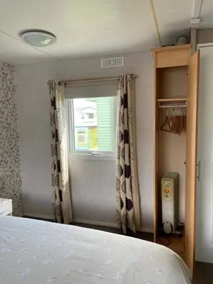a bedroom with a bed and a window at Seaside Arizona in Morecambe