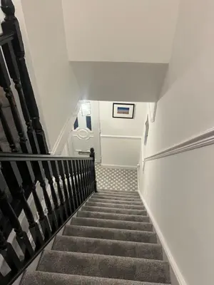 a staircase leading up to a building with white walls at Our Happy Place West Derby in Deysbrook