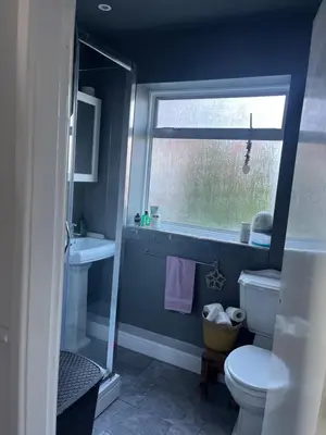 a bathroom with a toilet and a window at Our Happy Place West Derby in Deysbrook
