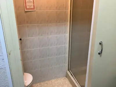 a bathroom with a shower with a toilet at King Edward Guesthouse in Blackpool