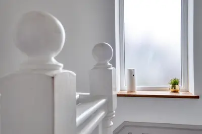 a white room with a window with a plant on a window sill at Westhoughton 3 Bedroom House - Free Parking in Westhoughton