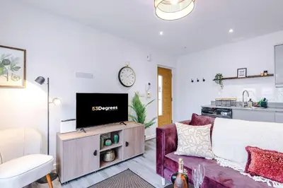 a living room with a couch and a tv at Centrally Located Formby Flat by 53 Degrees Property, Perfect for Work & Leisure in Formby