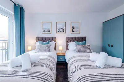 two beds sitting next to each other in a room at Centrally Located Formby Flat by 53 Degrees Property, Perfect for Work & Leisure in Formby