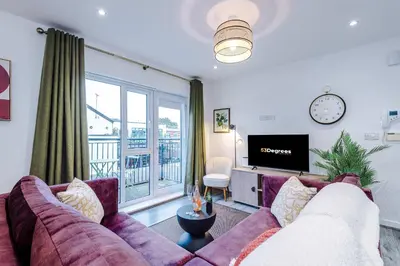 a living room with a couch and a tv at Centrally Located Formby Flat by 53 Degrees Property, Perfect for Work & Leisure in Formby