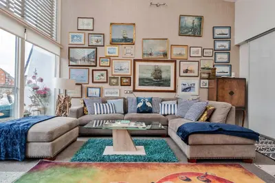 a living room with a couch and a table at Finest Retreats - The Houseboat, Liverpool Marina in Liverpool