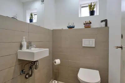 a bathroom with a white sink and a toilet at Finest Retreats - The Houseboat, Liverpool Marina in Liverpool