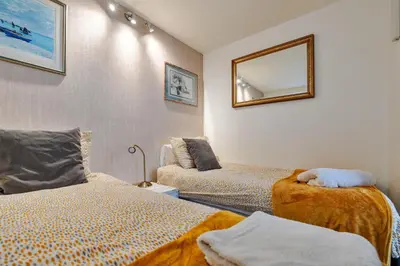 a room with two beds and a mirror on the wall at Finest Retreats - The Houseboat, Liverpool Marina in Liverpool