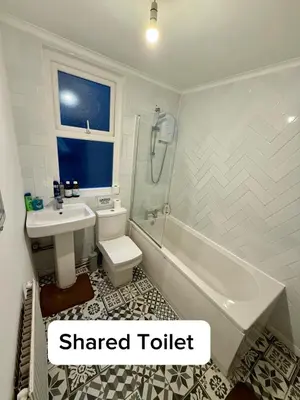 a bathroom with a sink and a toilet and a bath tub at The Coningsby Staycation in Liverpool