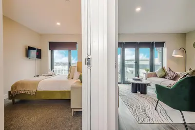a bedroom with a bed and a couch and a chair at Luxury 2-Bed Apt by Royal Albert Dock & M&S Arena in Liverpool