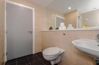a bathroom with a toilet and a sink at Luxury 2-Bed Apt by Royal Albert Dock & M&S Arena in Liverpool