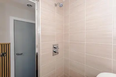 a shower stall with a toilet in a bathroom at Luxury 2-Bed Apt by Royal Albert Dock & M&S Arena in Liverpool