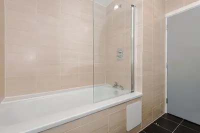 a bathroom with a tub and a glass shower at Luxury 2-Bed Apt by Royal Albert Dock & M&S Arena in Liverpool