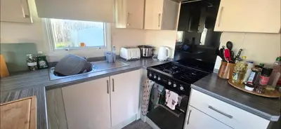 a kitchen with a stove and a counter top at Shellie's Summer Breeze Retreat in Heysham