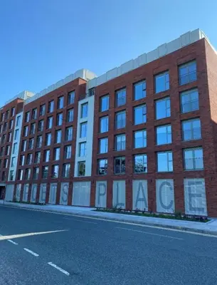 a large brick building on the side of a street at Poets Place Penthouse in Liverpool
