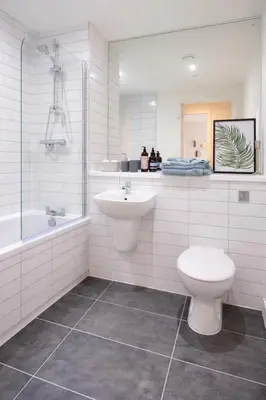 a bathroom with a sink and a toilet and a tub at Poets Place Penthouse in Liverpool