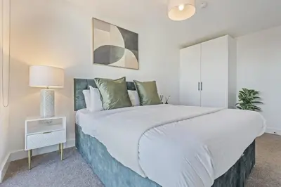 a white bedroom with a large bed and a lamp at Oriel Residence - 2BR - 4 Beds - Sleeps 5 in Liverpool