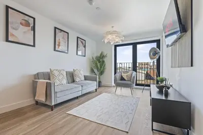 a living room with a couch and a table at Oriel Residence - 2BR - 4 Beds - Sleeps 5 in Liverpool