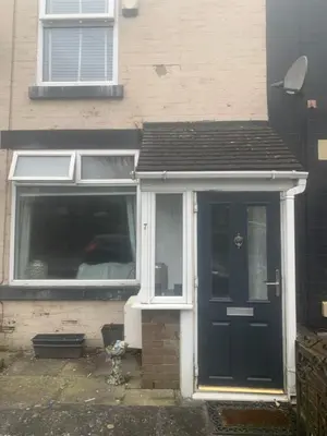 a house with a blue door and a window at 2 bedroom house in Horwich