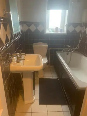 a bathroom with a sink and a toilet and a tub at 2 bedroom house in Horwich