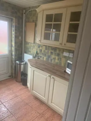 a kitchen with white cabinets and a counter top at 2 bedroom house in Horwich