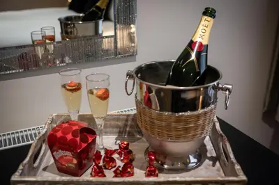 a bucket of champagne and two glasses and a box of hearts at Abbey Apartments - Modern Serviced Apartments - Tourists & Professionals in Barrow in Furness