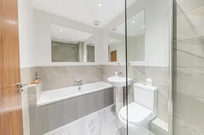 a bathroom with a toilet and a sink at Abbey Apartments - Modern Serviced Apartments - Tourists & Professionals in Barrow in Furness