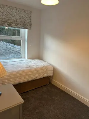 a small bedroom with a bed and a window at Beautiful 3 bedroom home, Dorrington Terrace in Lancaster