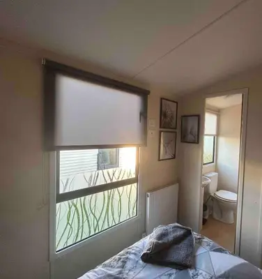a window in a room with a bed and a toilet at Charming Holiday Park Retreat in Morecambe - Family-Friendly Escape in Morecambe