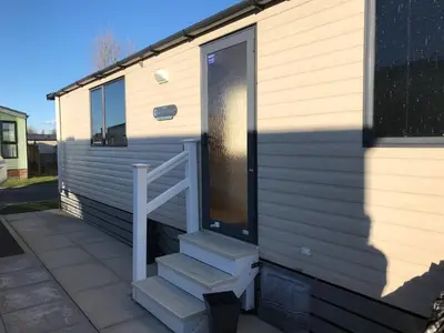 a stairway leading to the door of a tiny house at Charming Holiday Park Retreat in Morecambe - Family-Friendly Escape in Morecambe