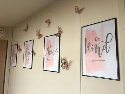 a wall with pictures and butterflies on it at Charming Holiday Park Retreat in Morecambe - Family-Friendly Escape in Morecambe