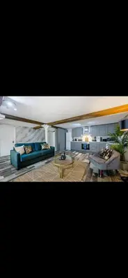 a living room with two couches and a table at Stylish Studio Apartment in Liverpool